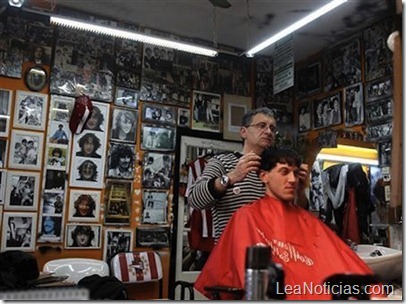 139918-hairstylist-gerardo-weiss-cuts-a-customers-hair-at-his-hairdressing-sa