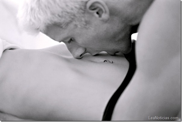 Man kissing woman's stomach