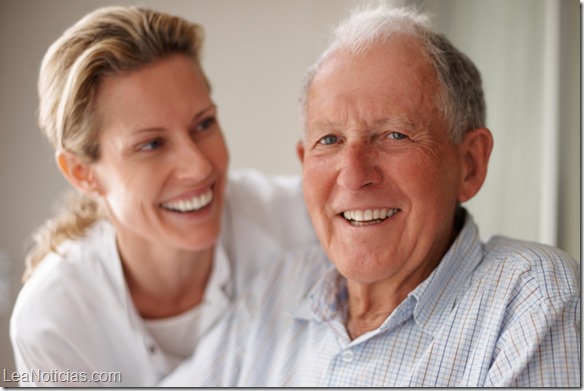 Closeup of a happy old man on the wheel chair with a nurse