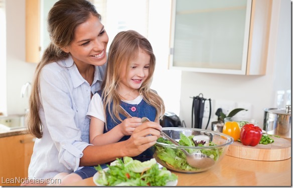 Mother and her daughter preparing a salad