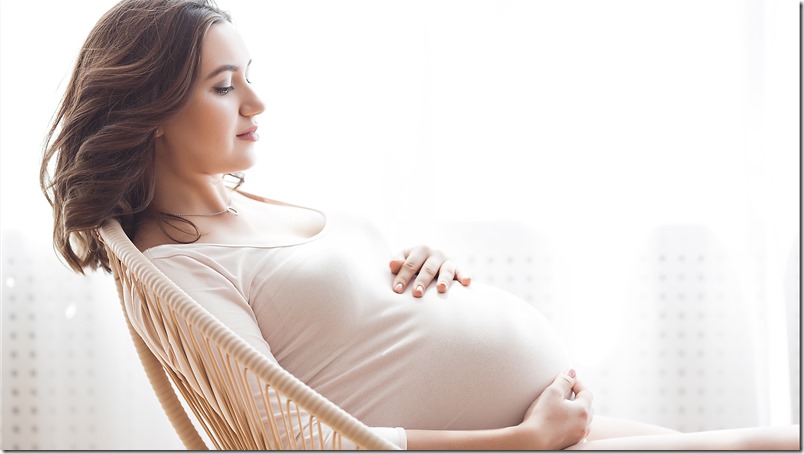 Beautiful pregnant woman on neutral background. Expectant closeup picture. Future mother portrait on pastel background.